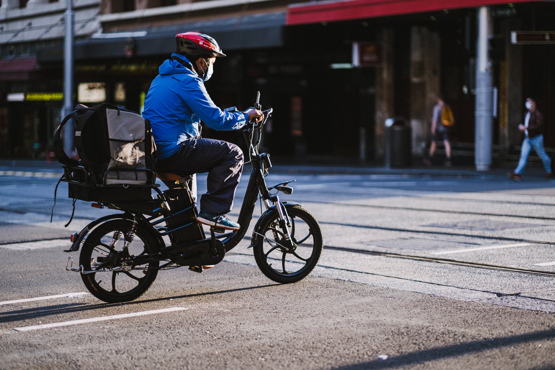 man in blue jacket riding motorcycle on road
