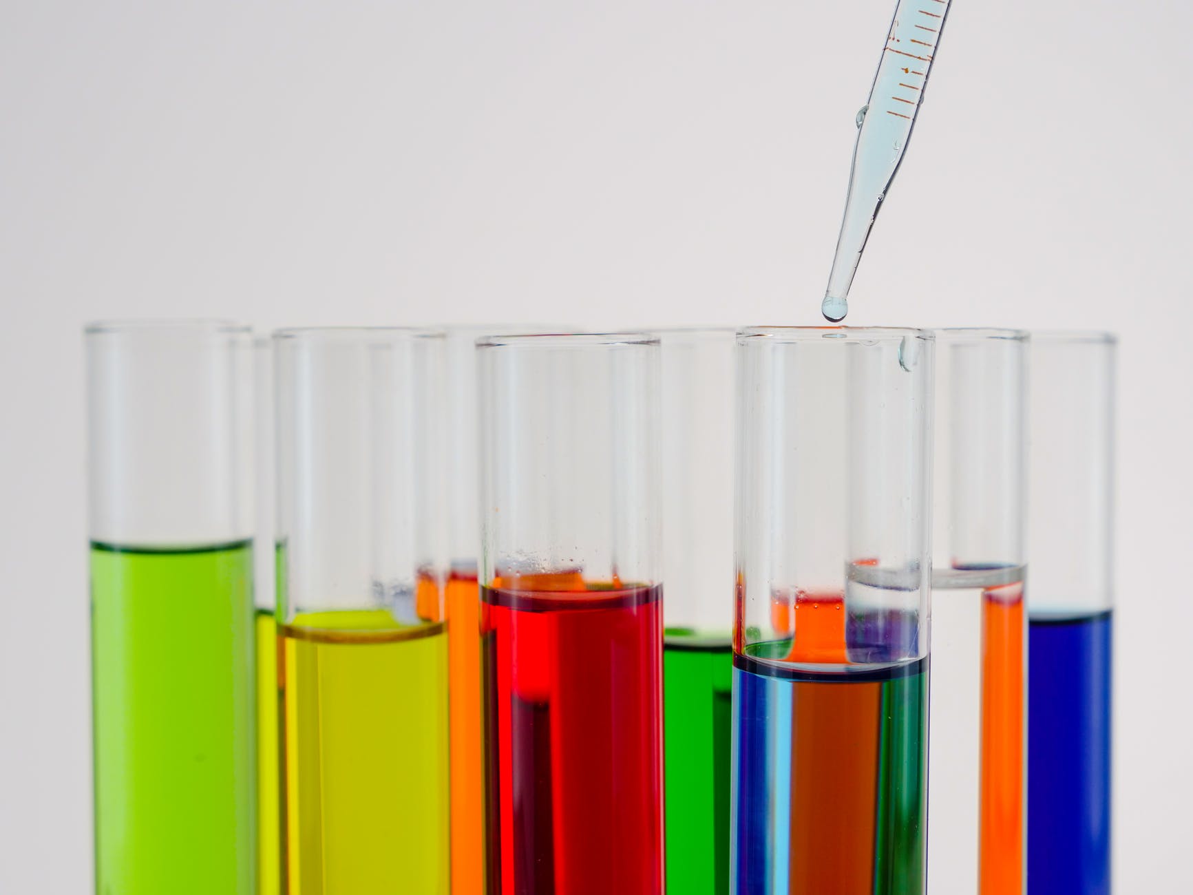 close up view of colorful liquids in test tubes